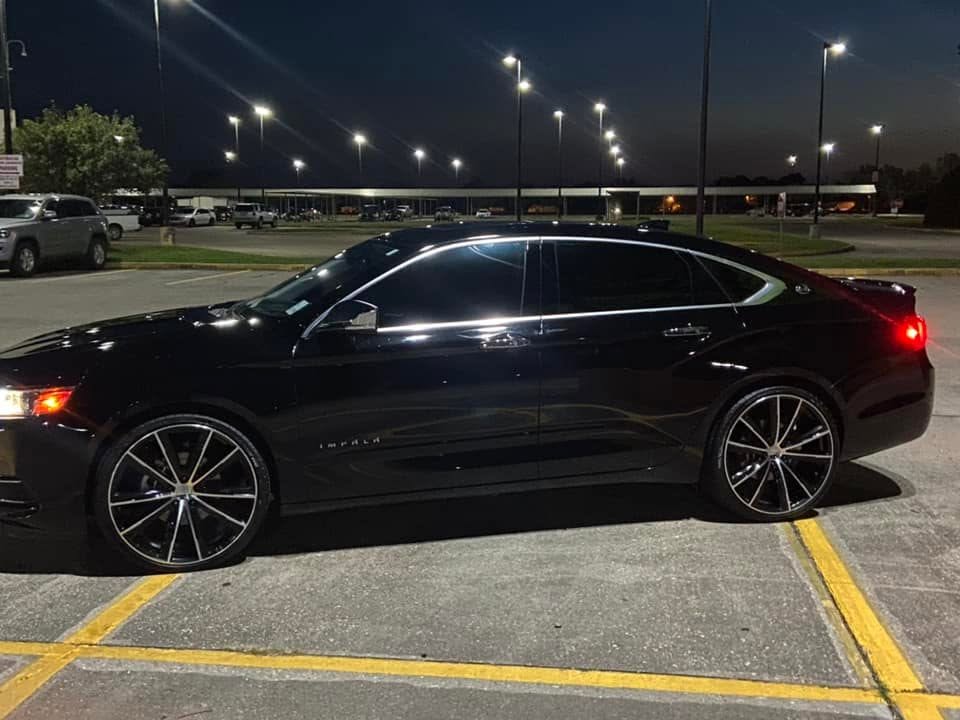 Black Chevy Impala glossy under parking lot lights