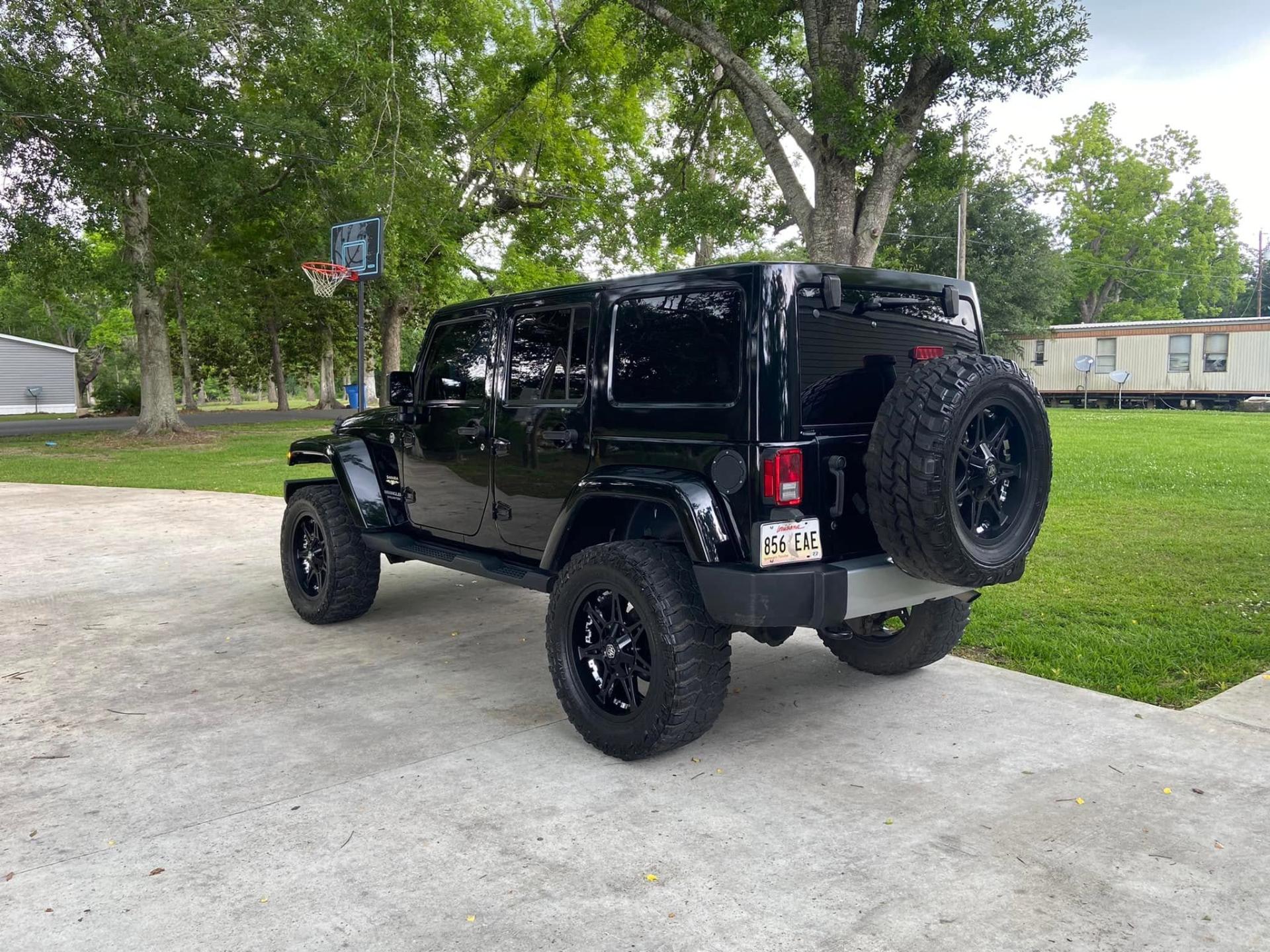 Lifted black Jeep Wrangler detailed to a deep gloss